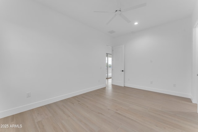 spare room featuring ceiling fan and light hardwood / wood-style flooring