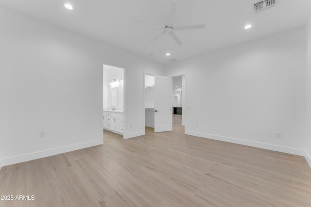 unfurnished bedroom featuring light wood-type flooring, ceiling fan, and ensuite bathroom