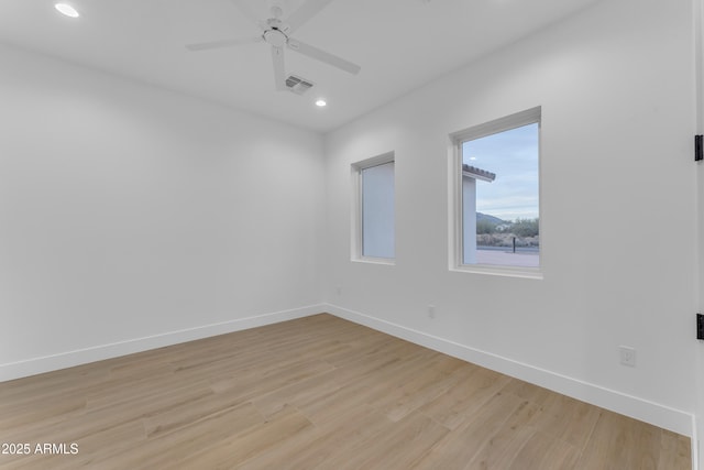 empty room featuring ceiling fan and light hardwood / wood-style floors