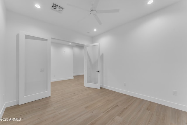 spare room featuring ceiling fan and light hardwood / wood-style floors