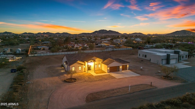 aerial view at dusk featuring a mountain view