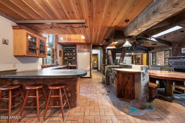 bar featuring beam ceiling, high quality appliances, sink, and wood ceiling