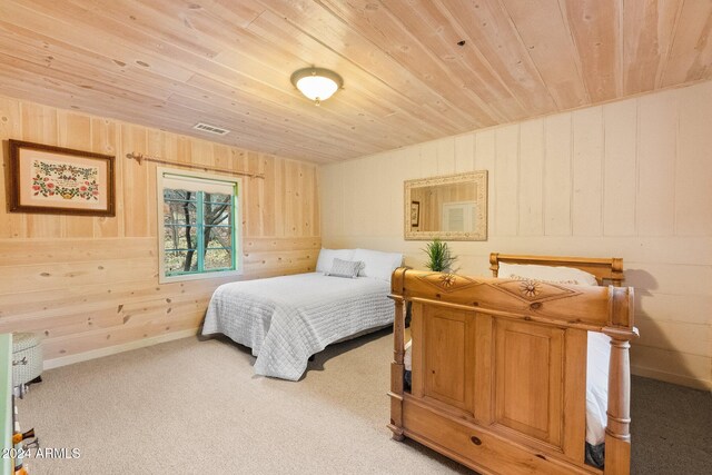 carpeted bedroom featuring wooden walls and wooden ceiling