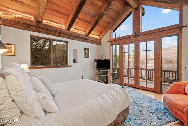 bedroom featuring beam ceiling, access to exterior, french doors, wood-type flooring, and wood ceiling