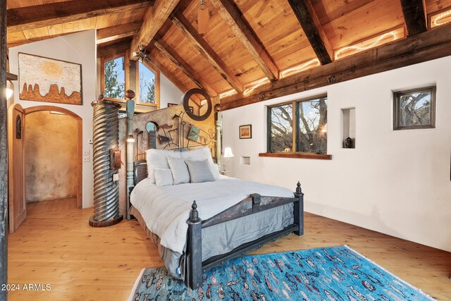 bedroom with vaulted ceiling with beams, light wood-type flooring, and wood ceiling