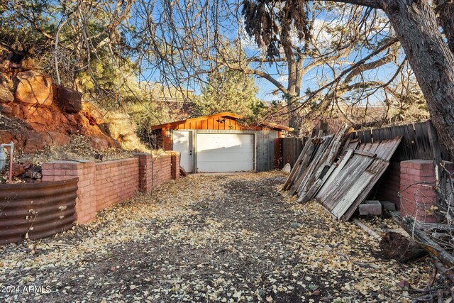 view of yard featuring an outbuilding and a garage