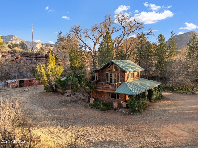 rear view of house featuring a mountain view