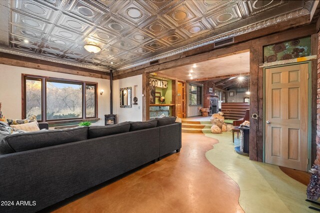 living room with concrete floors and a wood stove