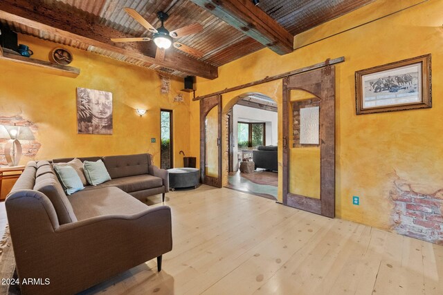 living room featuring beam ceiling, ceiling fan, wooden ceiling, and light hardwood / wood-style floors