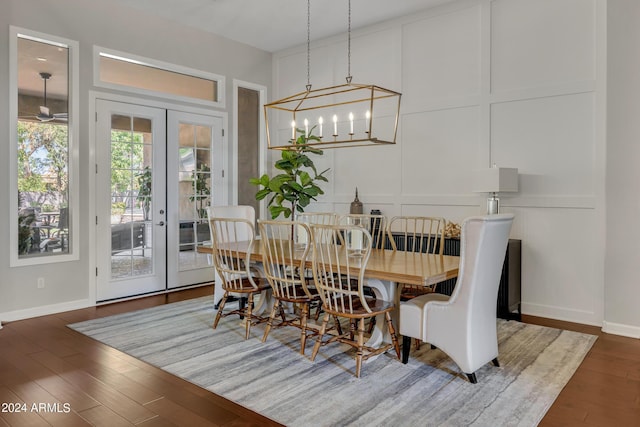 dining space featuring french doors, dark wood-type flooring, and a notable chandelier