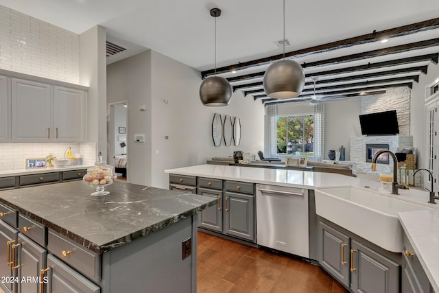 kitchen featuring dishwasher, sink, hanging light fixtures, gray cabinets, and a kitchen island