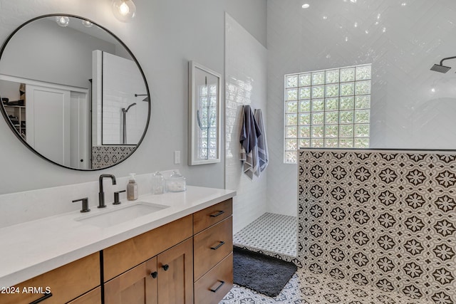 bathroom with vanity and tiled shower