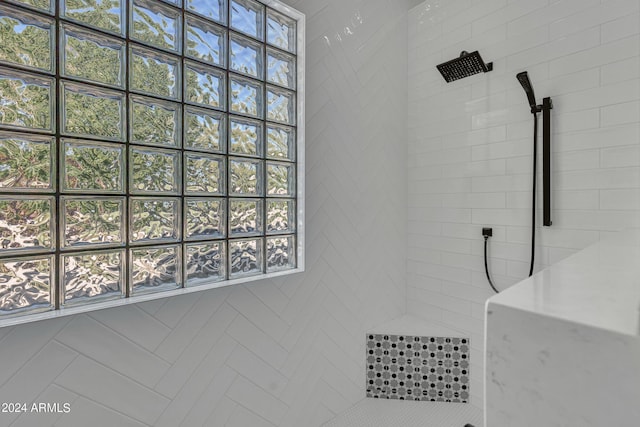 bathroom with tiled shower