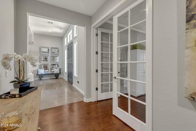 hallway with french doors and hardwood / wood-style flooring