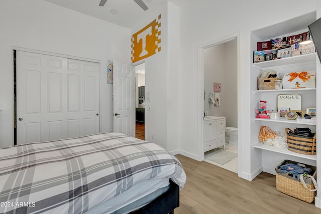 bedroom featuring ceiling fan, ensuite bath, light hardwood / wood-style flooring, and a closet