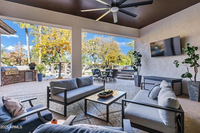 view of patio with area for grilling, ceiling fan, and an outdoor hangout area