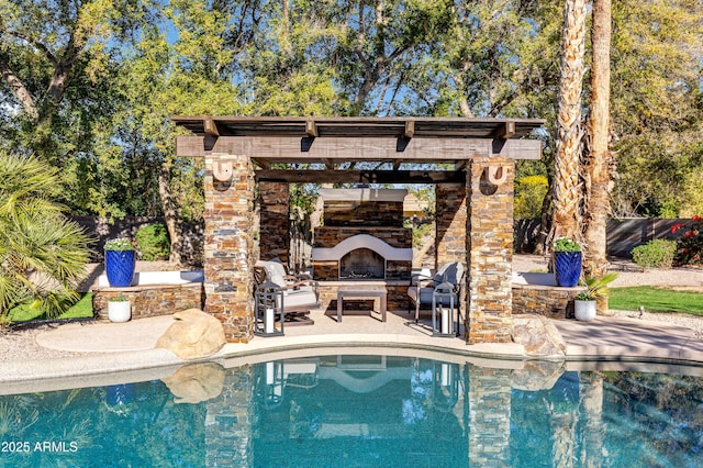 view of swimming pool with a patio area and exterior fireplace