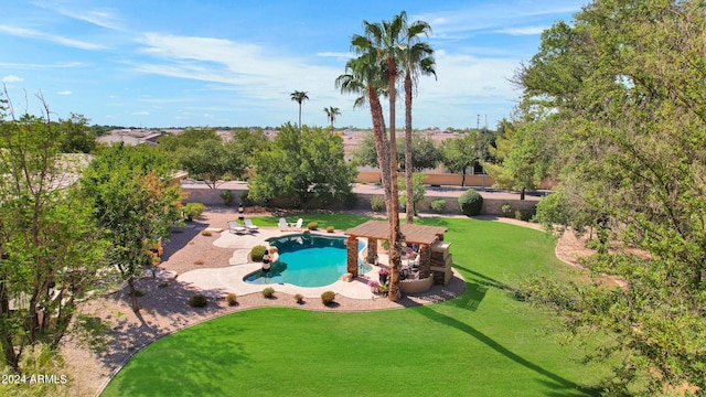 view of pool with a lawn