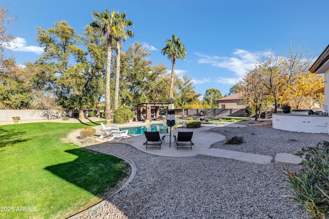 view of yard with a fenced in pool and a patio