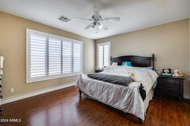 bedroom with ceiling fan and dark wood-type flooring