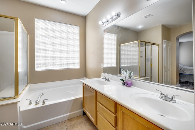 bathroom with tile patterned flooring, vanity, and plus walk in shower