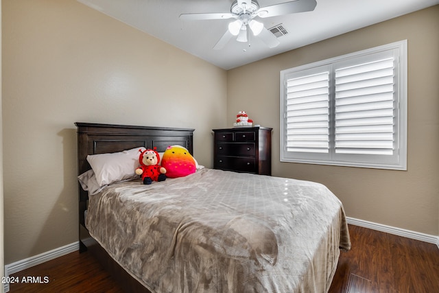 bedroom with dark hardwood / wood-style flooring and ceiling fan