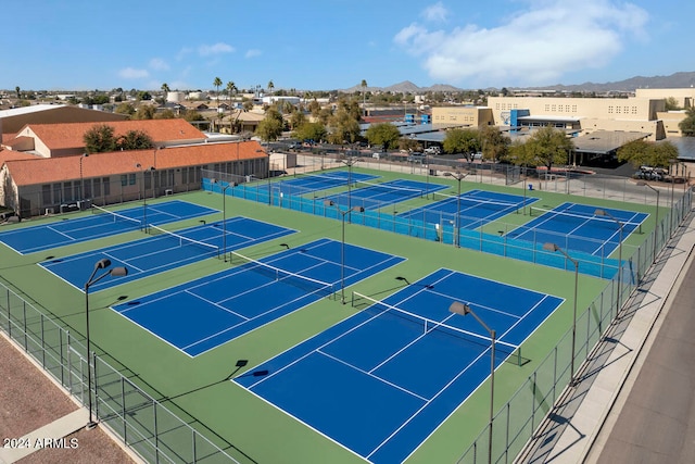 view of tennis court featuring a mountain view