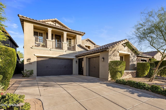 3741 E Ember Glow Way, Phoenix, AZ 85050 - mediterranean / spanish-style home with a balcony, stucco siding, concrete driveway, a tile roof, and an attached garage