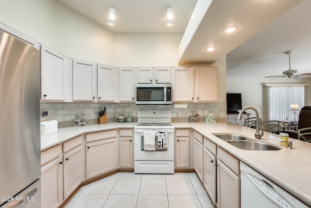 kitchen with sink, ceiling fan, decorative backsplash, light tile patterned floors, and appliances with stainless steel finishes