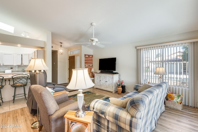 living room featuring ceiling fan and light wood-type flooring