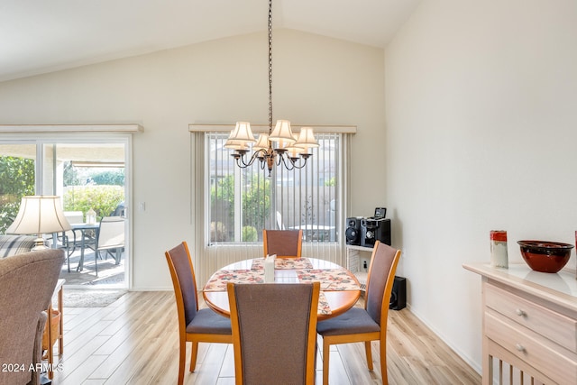 dining room featuring a notable chandelier, light wood-type flooring, and vaulted ceiling