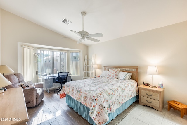 bedroom with ceiling fan, light hardwood / wood-style flooring, and lofted ceiling