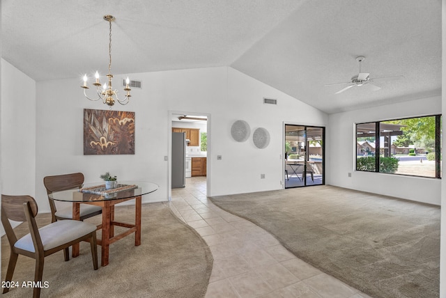 carpeted dining area featuring ceiling fan with notable chandelier, lofted ceiling, a textured ceiling, and a wealth of natural light