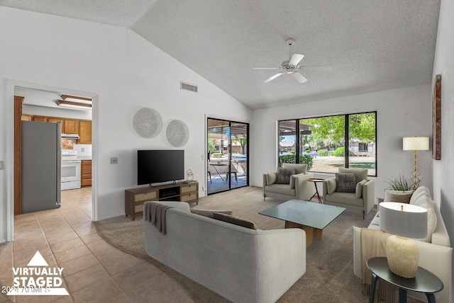 living room featuring ceiling fan, light tile patterned floors, a textured ceiling, and high vaulted ceiling