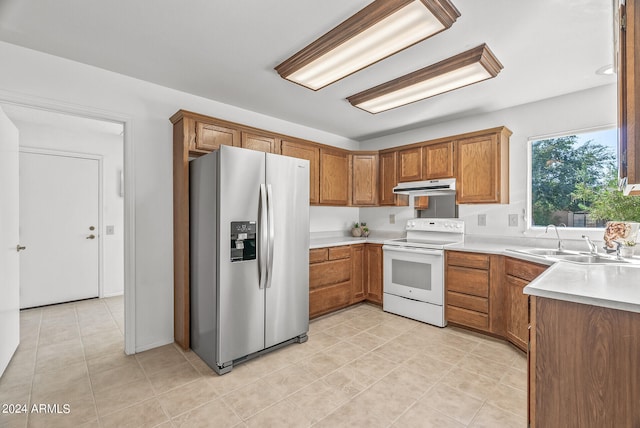 kitchen featuring white range with electric cooktop, stainless steel fridge with ice dispenser, sink, and light tile patterned flooring