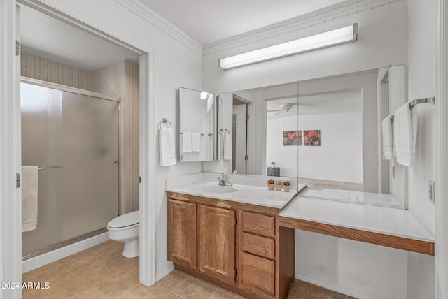 bathroom featuring vanity, a shower with door, tile patterned floors, ceiling fan, and toilet