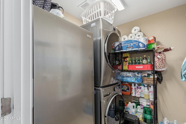 laundry room with stacked washing maching and dryer