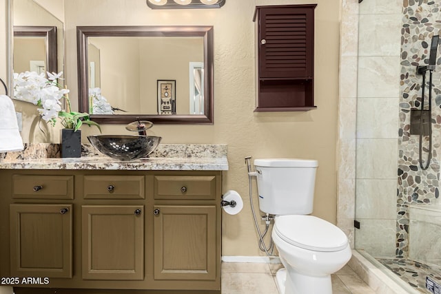 bathroom featuring vanity, an enclosed shower, tile patterned floors, and toilet