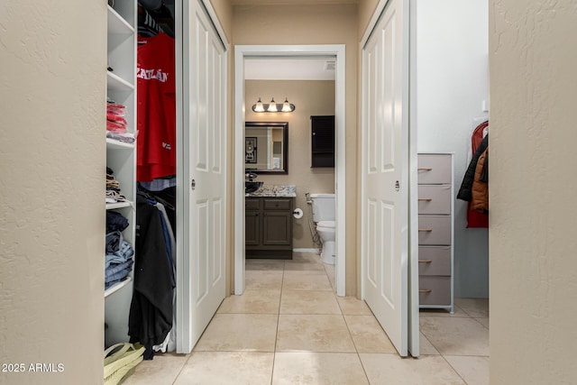 hall featuring light tile patterned flooring