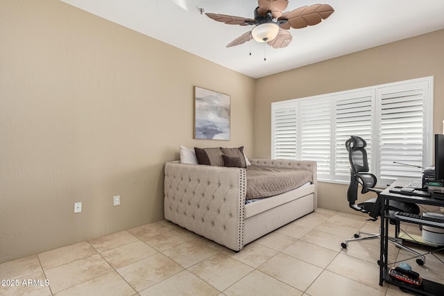 tiled bedroom featuring ceiling fan