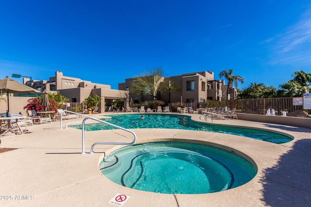 view of swimming pool featuring a community hot tub and a patio area