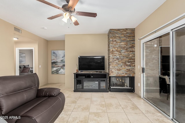 living room featuring light tile patterned floors and ceiling fan