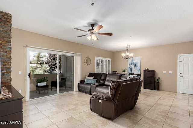 tiled living room with ceiling fan with notable chandelier