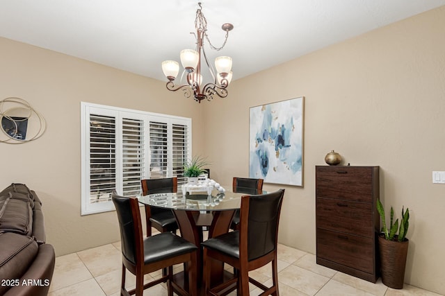 dining room featuring a notable chandelier and light tile patterned flooring