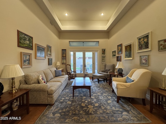 living room with hardwood / wood-style floors, french doors, and a high ceiling