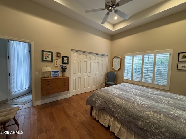 bedroom featuring wood-type flooring, a closet, and ceiling fan