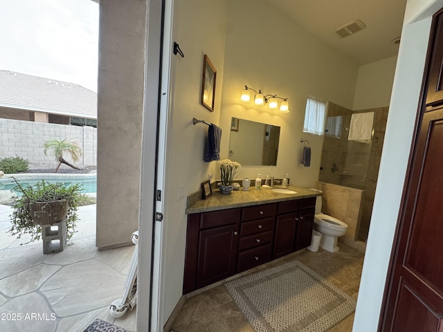 bathroom with tile patterned flooring, vanity, and toilet