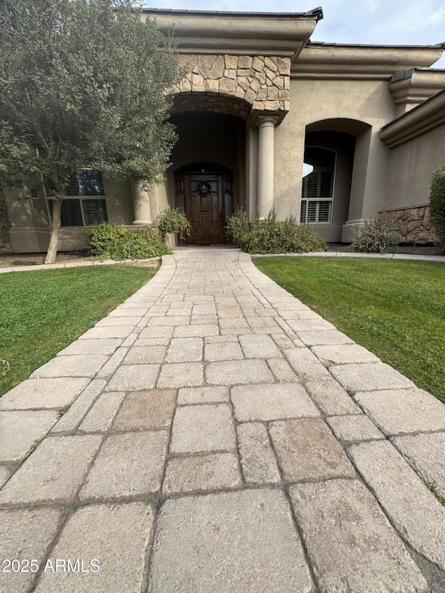 doorway to property featuring a yard