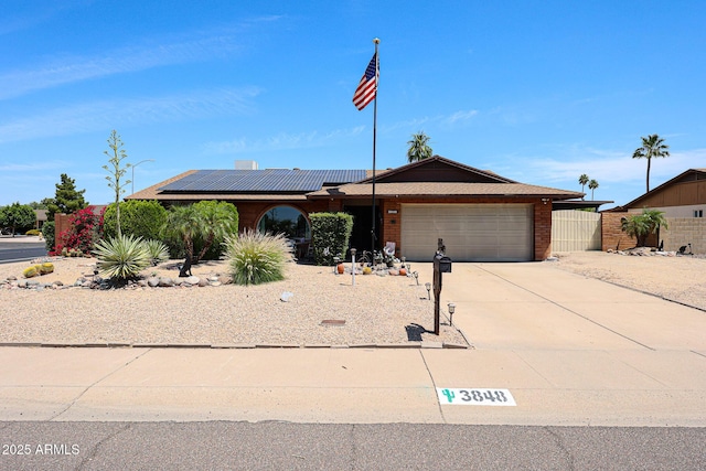 3848 W Kings Ave, Phoenix, AZ 85053 - ranch-style home with roof mounted solar panels, a garage, concrete driveway, and brick siding