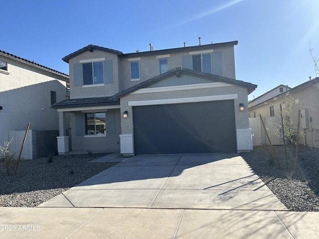 traditional-style house with a garage, driveway, fence, and stucco siding